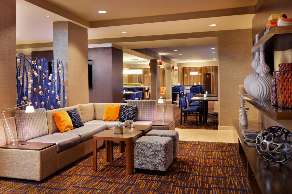 a living room with a couch and a table at Courtyard by Marriott Gainesville FL in Gainesville