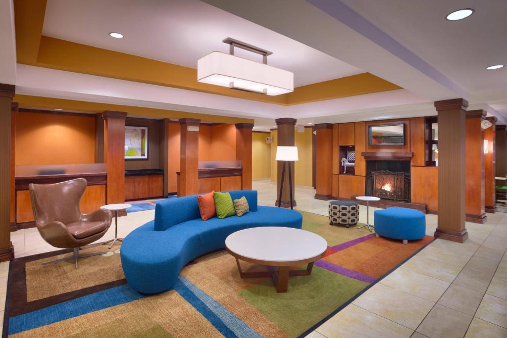 a living room with a blue couch and a table at Fairfield Inn & Suites by Marriott Gillette in Gillette