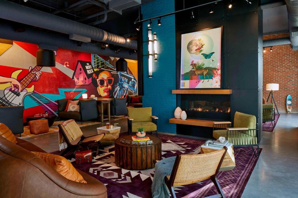 a living room filled with furniture and a fireplace at Moxy Chattanooga Downtown in Chattanooga