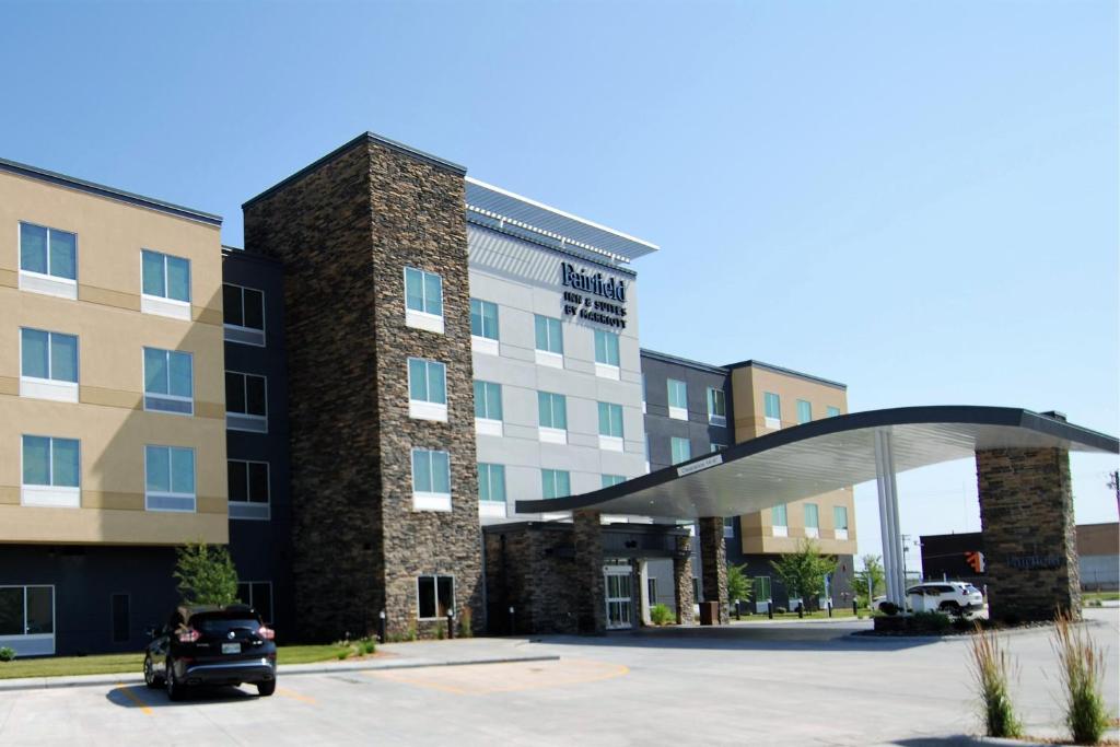 a car parked in a parking lot in front of a building at Fairfield Inn & Suites Winona in Winona