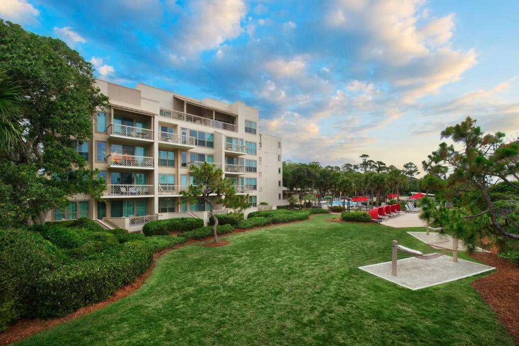 a large apartment building with a park in front of it at Marriott's Monarch at Sea Pines in Hilton Head Island