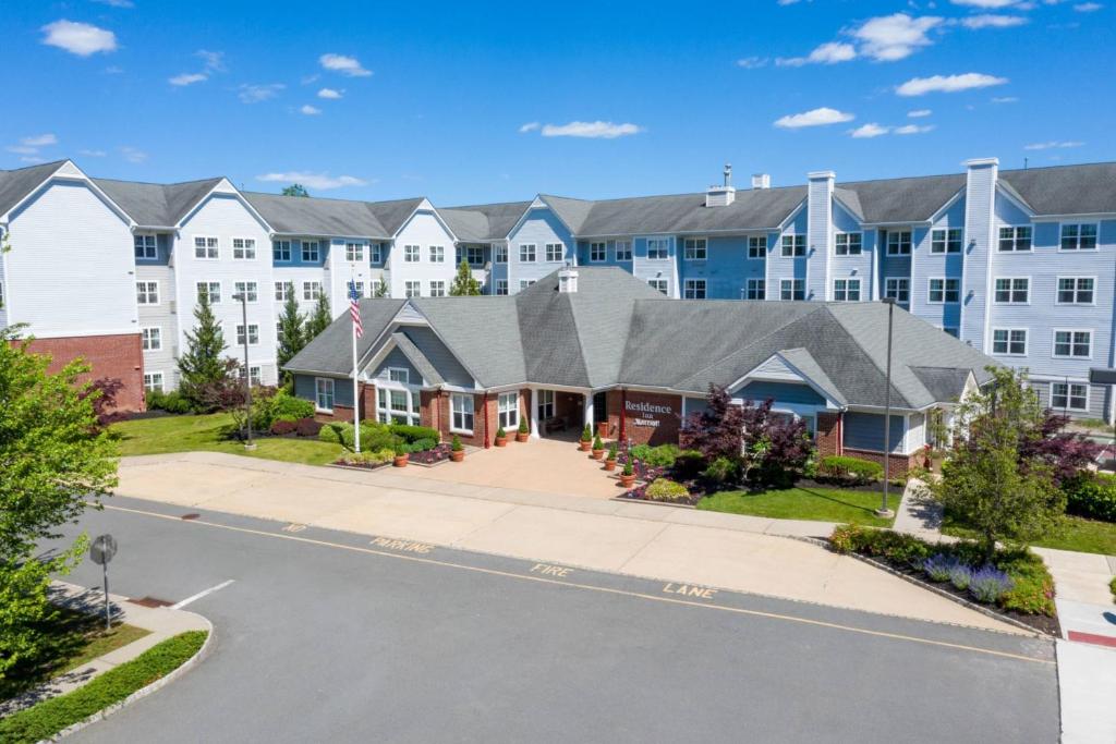 a large apartment building with a street in front at Residence Inn by Marriott Princeton at Carnegie Center in Princeton