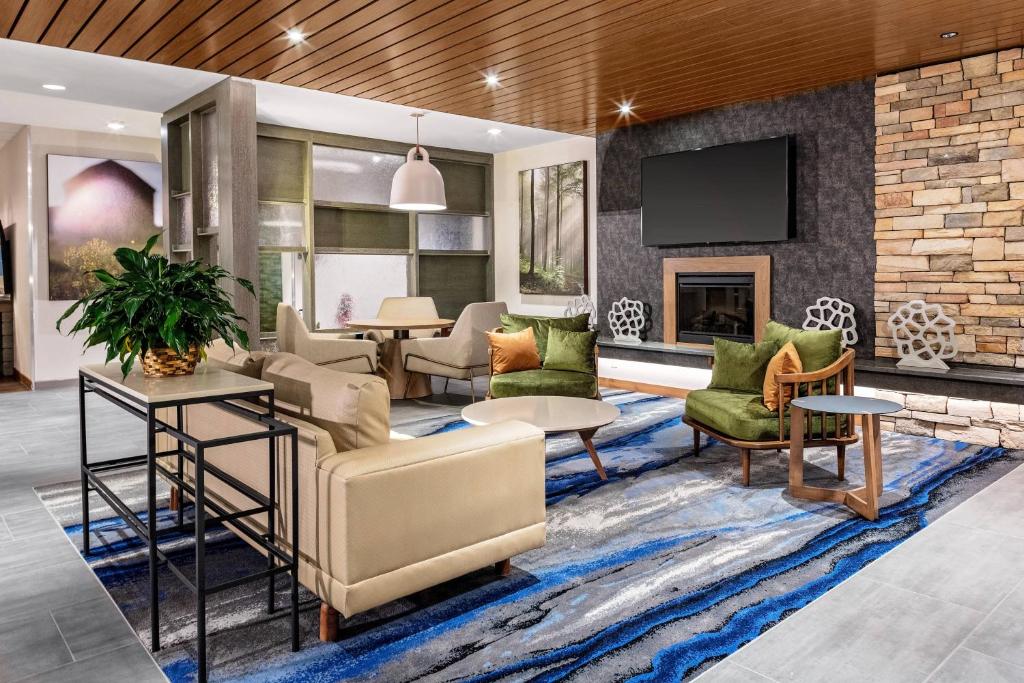 a lobby with furniture and a fireplace at Fairfield Inn & Suites by Marriott Queensbury Glens Falls/Lake George in Queensbury