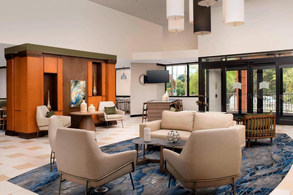 a living room with a couch and chairs at Fairfield Inn & Suites by Marriott Miami Airport South in Miami