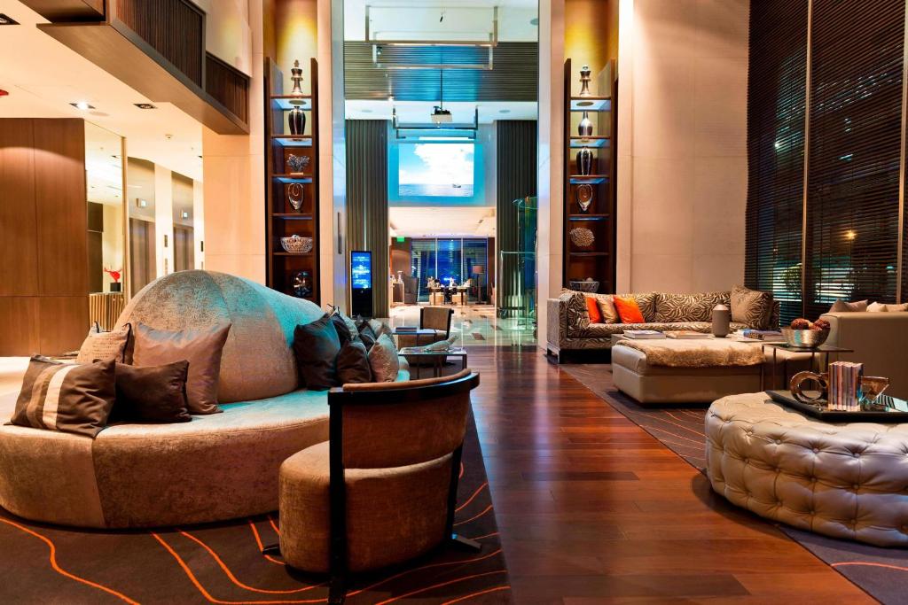 a lobby with a couch and chairs in a building at Renaissance Santiago by Marriott in Santiago