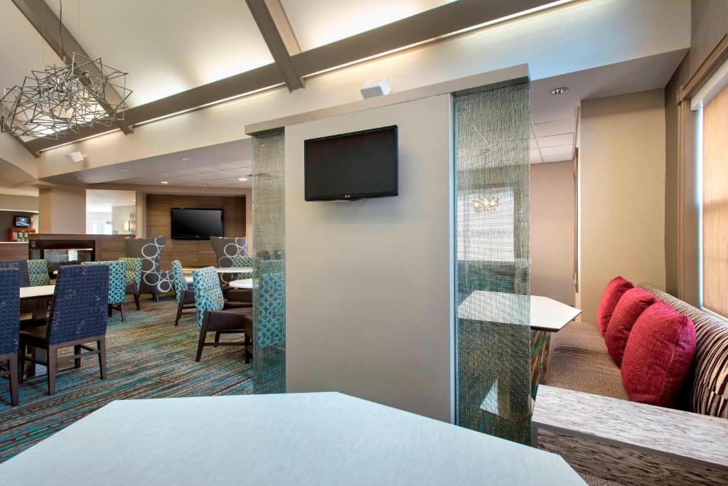 a lobby with a waiting room with a tv on a wall at Residence Inn Cranbury South Brunswick in Cranbury