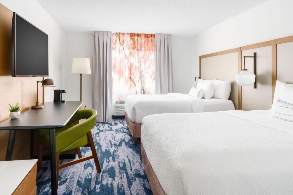 a hotel room with two beds and a desk at Fairfield Inn by Marriott Joliet South in Joliet