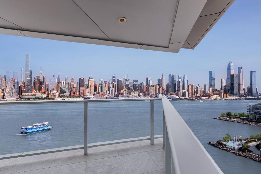 a view of a large city from a balcony at Envue, Autograph Collection in Weehawken