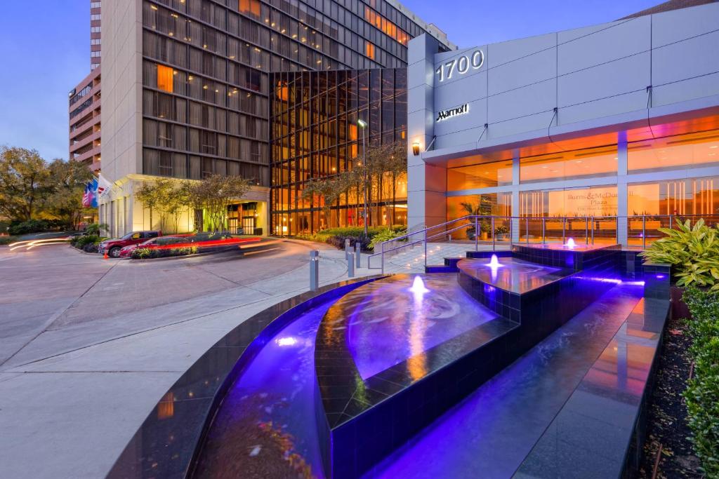 a building with a fountain in front of a building at Houston Marriott West Loop by The Galleria in Houston