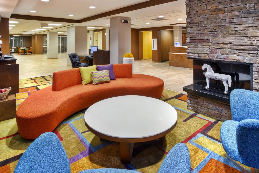 a lobby with a couch and a fireplace at Fairfield Inn Owensboro in Owensboro