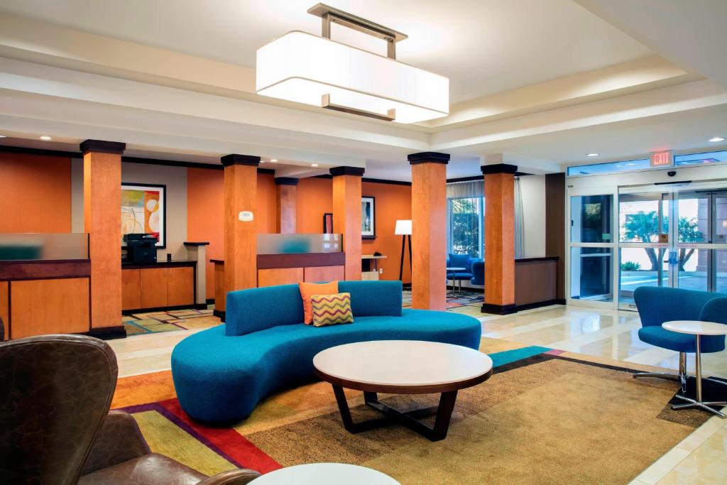 a living room with a blue couch and a table at Fairfield Inn and Suites by Marriott Lakeland Plant City in Plant City