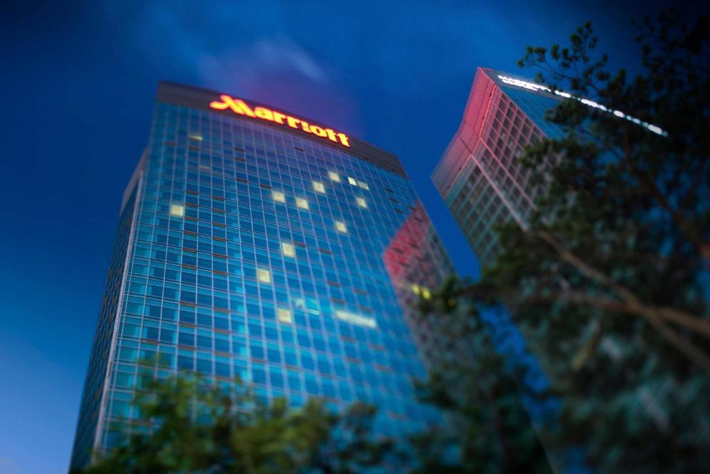 a tall building with a sign on top of it at Marriott Executive Apartment Seoul in Seoul