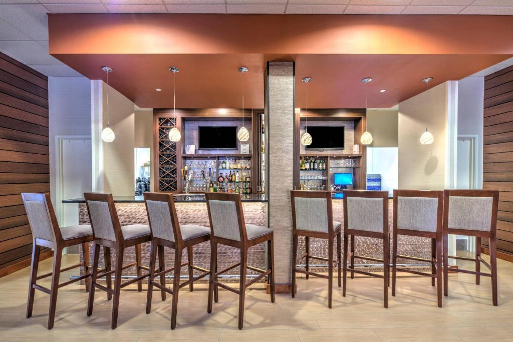 a bar with chairs and a counter in a room at Fairfield Inn and Suites by Marriott Durham Southpoint in Durham