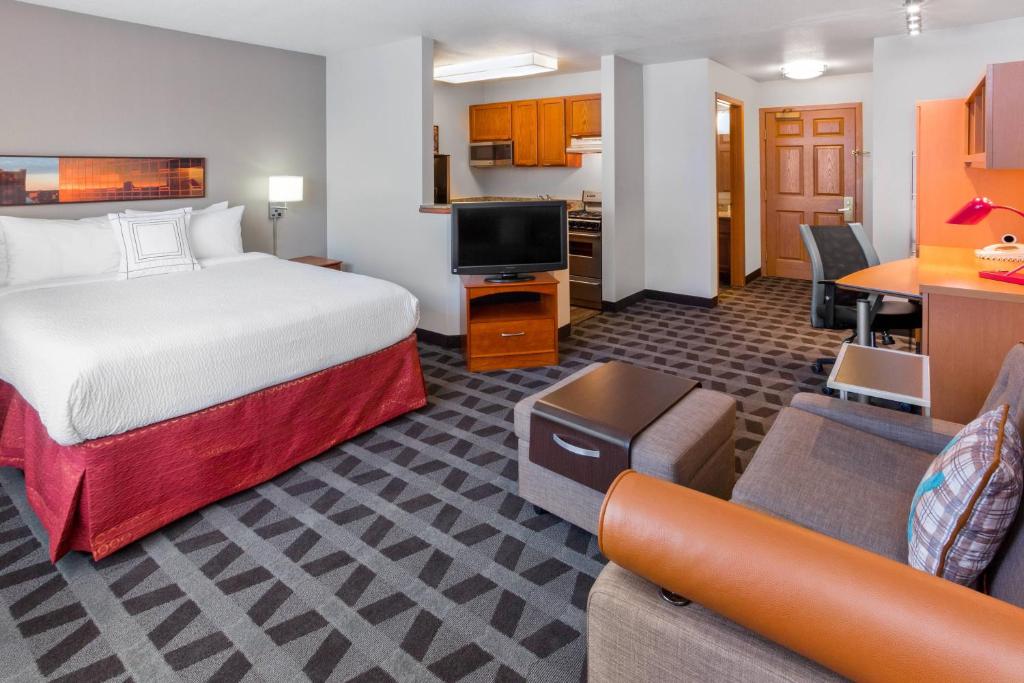 Habitación de hotel con cama y sala de estar. en TownePlace Suites Minneapolis West/St. Louis Park, en Saint Louis Park