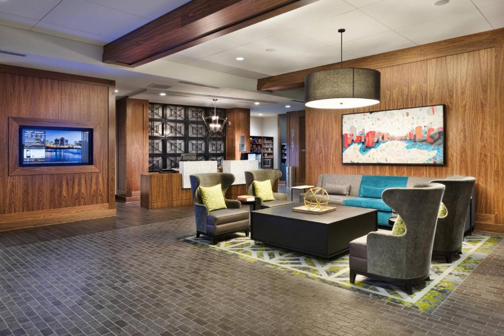 a lobby of a hotel with couches and chairs at Courtyard by Marriott Richmond Downtown in Richmond