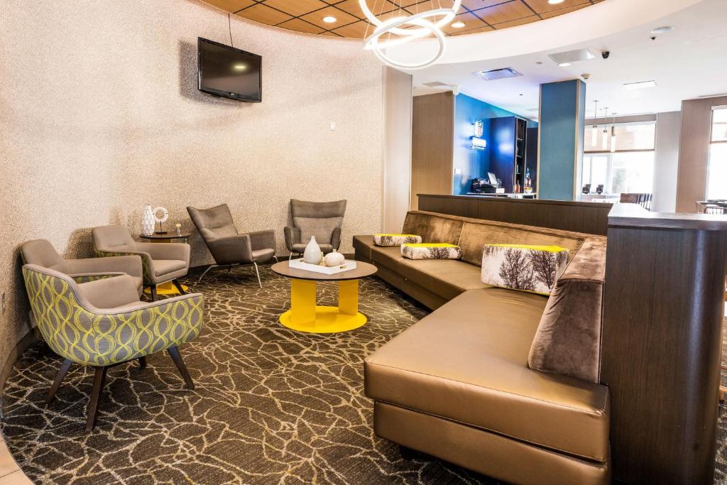 a lobby with a couch and chairs and a table at Springhill Suites by Marriott San Antonio Alamo Plaza/Convention Center in San Antonio