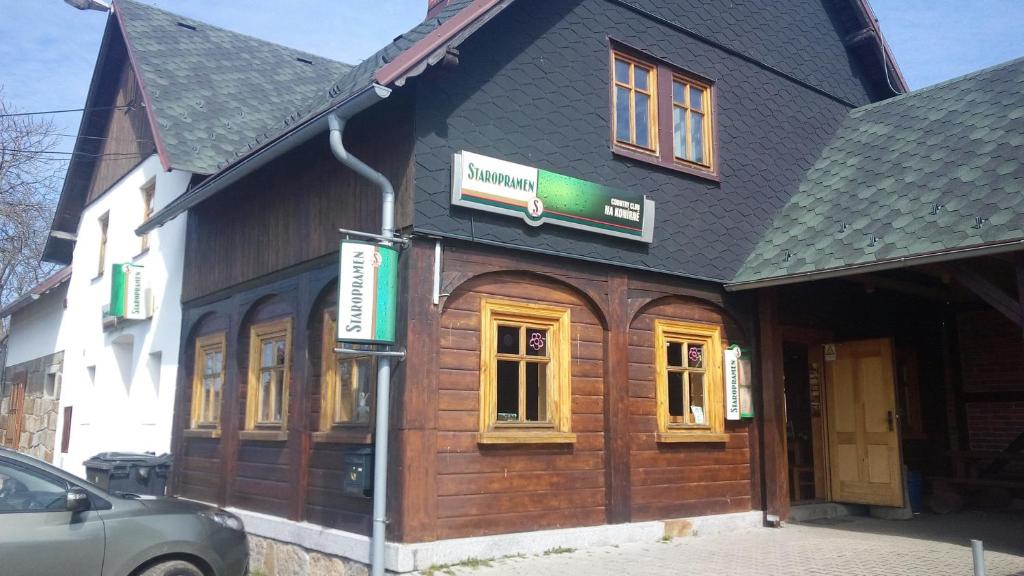 a building with a sign on the front of it at Country club Konírna in Šluknov