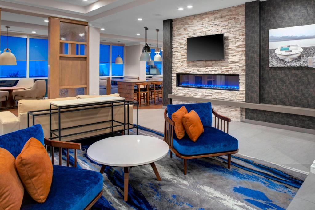 a living room with two chairs and a table at Fairfield Inn & Suites by Marriott Virginia Beach Oceanfront in Virginia Beach