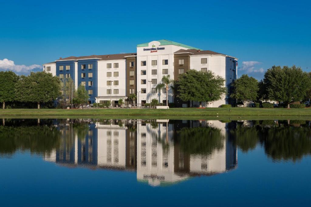 a building with its reflection in a body of water at SpringHill Suites by Marriott Orlando North-Sanford in Sanford