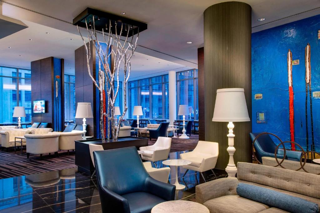 a lobby of a hotel with chairs and tables at Residence Inn by Marriott New York Manhattan/Central Park in New York