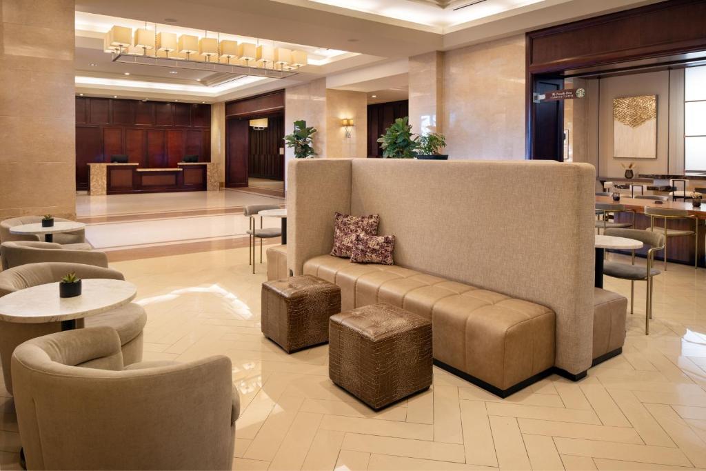 a lobby with a couch and chairs and tables at Sheraton Garden Grove-Anaheim South in Anaheim