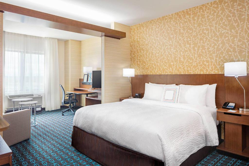 a hotel room with a large bed and a desk at Fairfield Inn & Suites by Marriott North Bergen in North Bergen