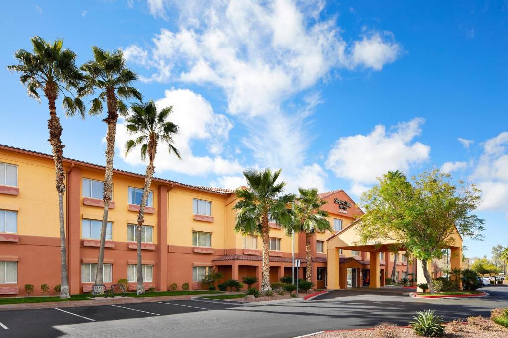 an exterior view of a hotel with palm trees at SpringHill Suites Tempe at Arizona Mills Mall in Tempe