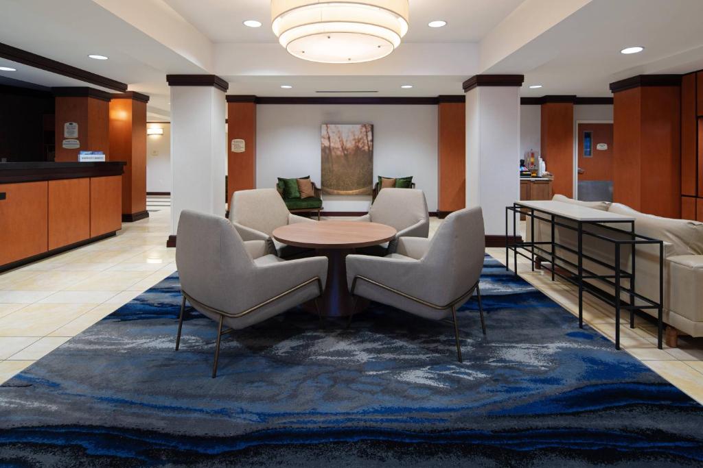 a lobby with chairs and a table and a waiting room at Fairfield Inn & Suites Seattle Bremerton in Bremerton