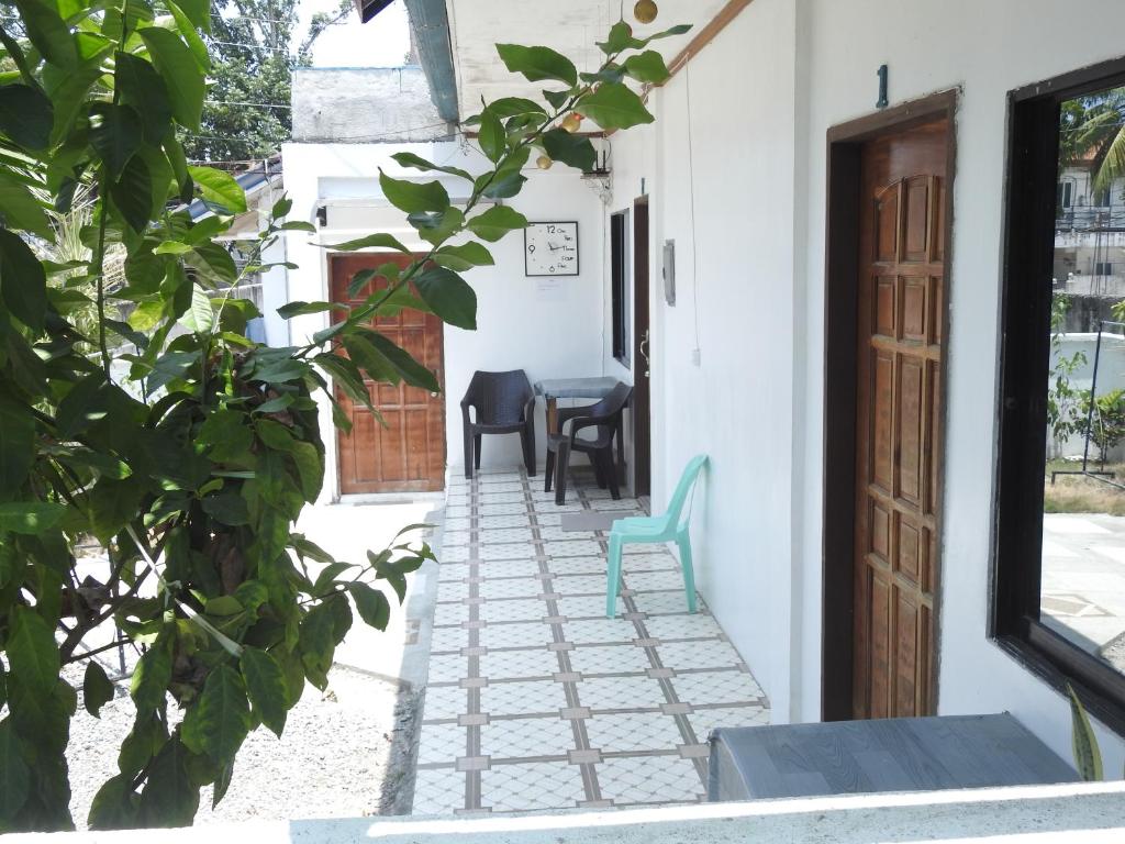 a hallway of a house with a blue chair at Pacifico Seaside Lodge in Moalboal