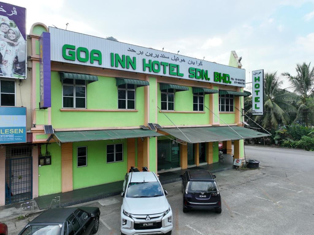 a building with cars parked in a parking lot at GOA INN HOTEL SDN BHD in Gua Musang