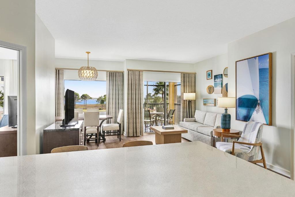 a living room with a couch and a table at Marriott&#39;s Legends Edge at Bay Point in Panama City Beach