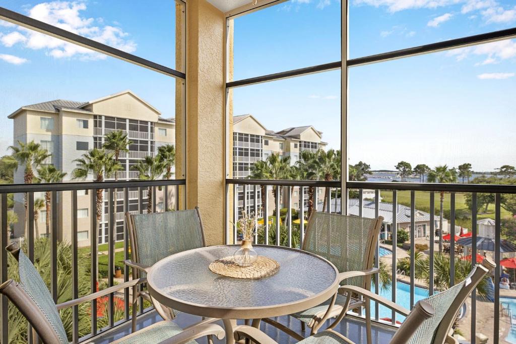 a balcony with a table and chairs and a view of a pool at Marriott&#39;s Legends Edge at Bay Point in Panama City Beach