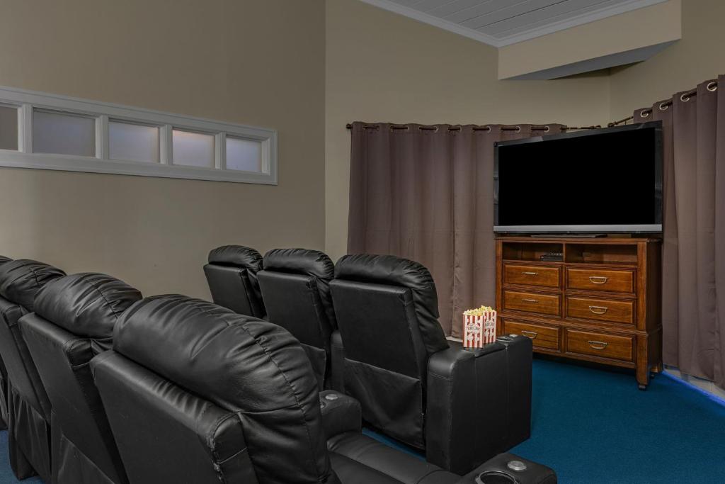 a living room with black leather chairs and a flat screen tv at Marriott&#39;s Legends Edge at Bay Point in Panama City Beach
