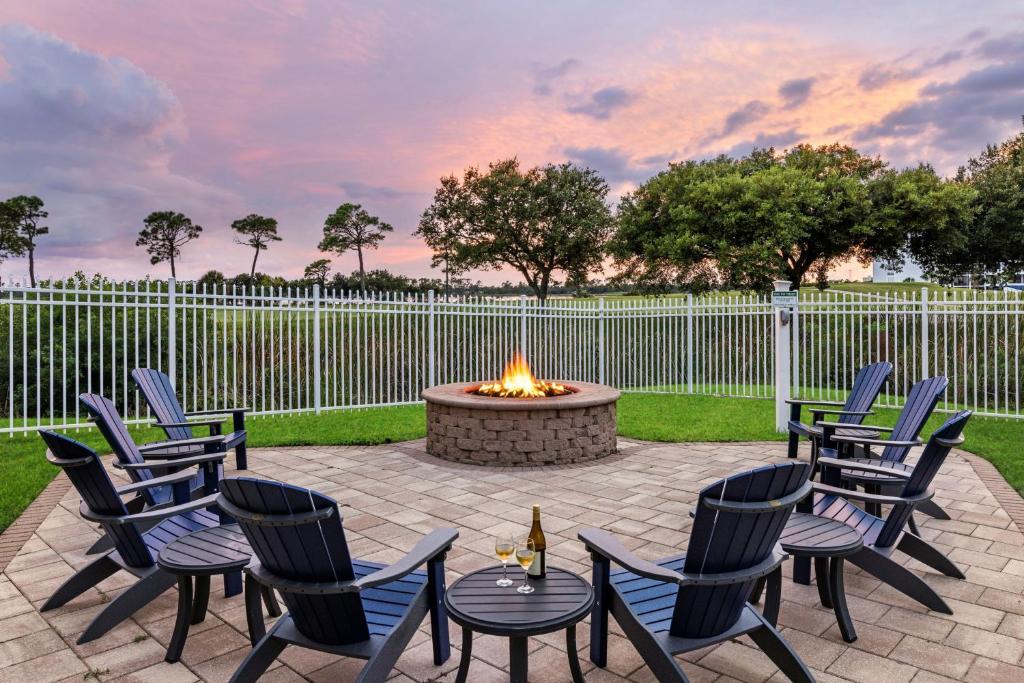 a patio with chairs and a fire pit with a fence at Marriott&#39;s Legends Edge at Bay Point in Panama City Beach