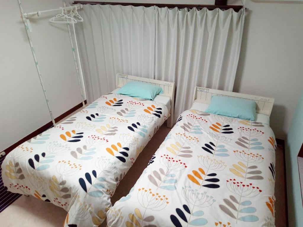 Postel nebo postele na pokoji v ubytování Mike's B&B Tokoname