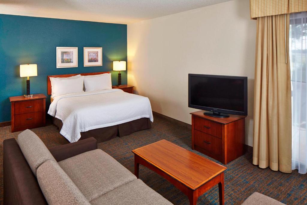 a hotel room with a bed and a flat screen tv at Residence Inn Minneapolis Eden Prairie in Eden Prairie