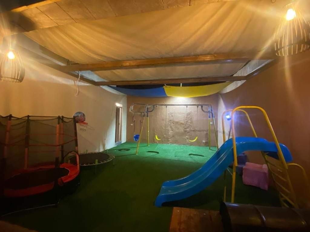 a play room with a slide and a playground at Tala Villa in Amman