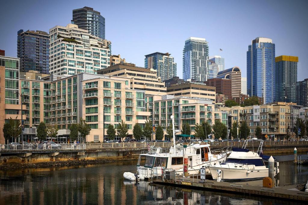 two boats docked at a marina in a city at Seattle Marriott Waterfront in Seattle