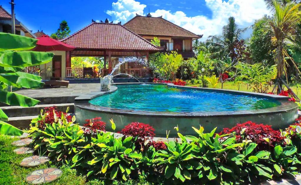 a swimming pool in the yard of a house at Pondok Ayu Soca in Ubud