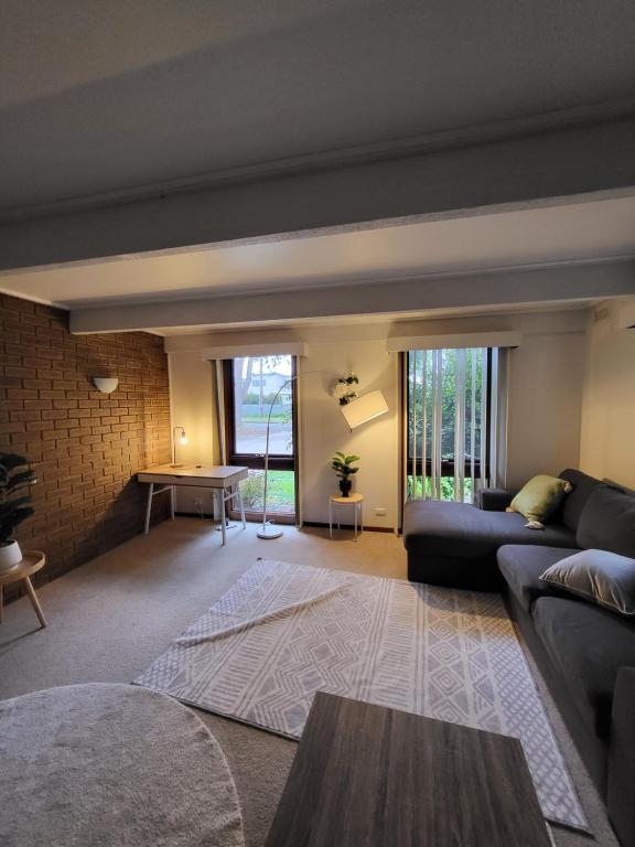 a living room with a couch and a table at Warm Cosy Paynesville Get-Away in Paynesville
