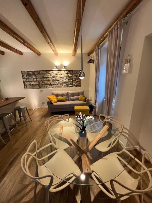 a living room with a glass table and a couch at LaLucia Luxury Suite Lake Como in Argegno