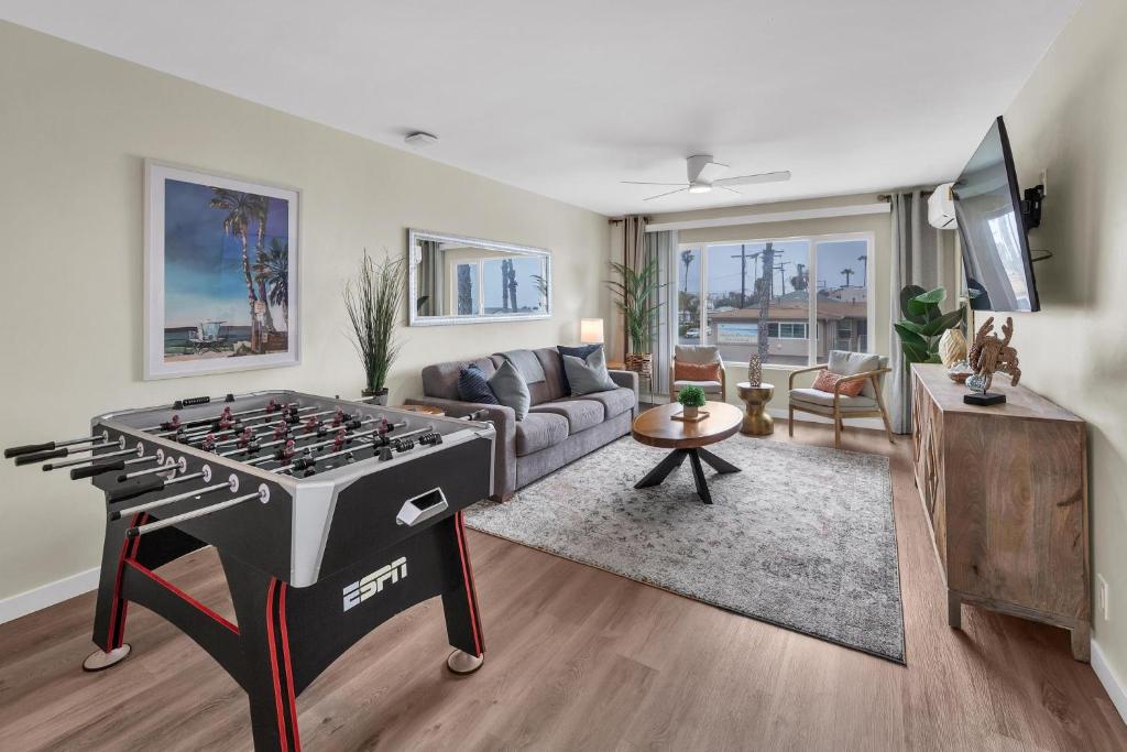 a living room with a ping pong table in the middle at Tower 9 #5 in Oceanside