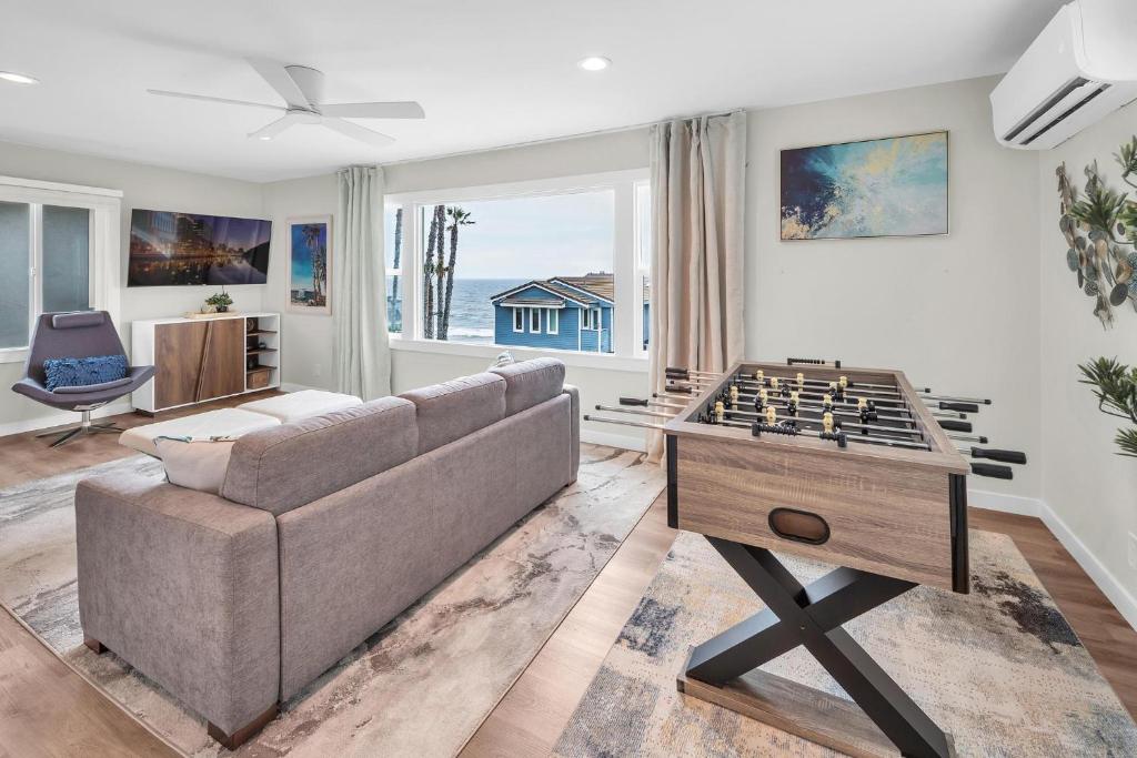 a living room with a couch and a foosball table at Tower 9 #2 in Oceanside