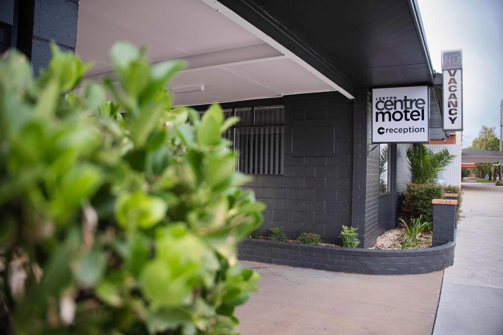 a building with a sign for a coffee motel at Leeton Centre Motel in Leeton