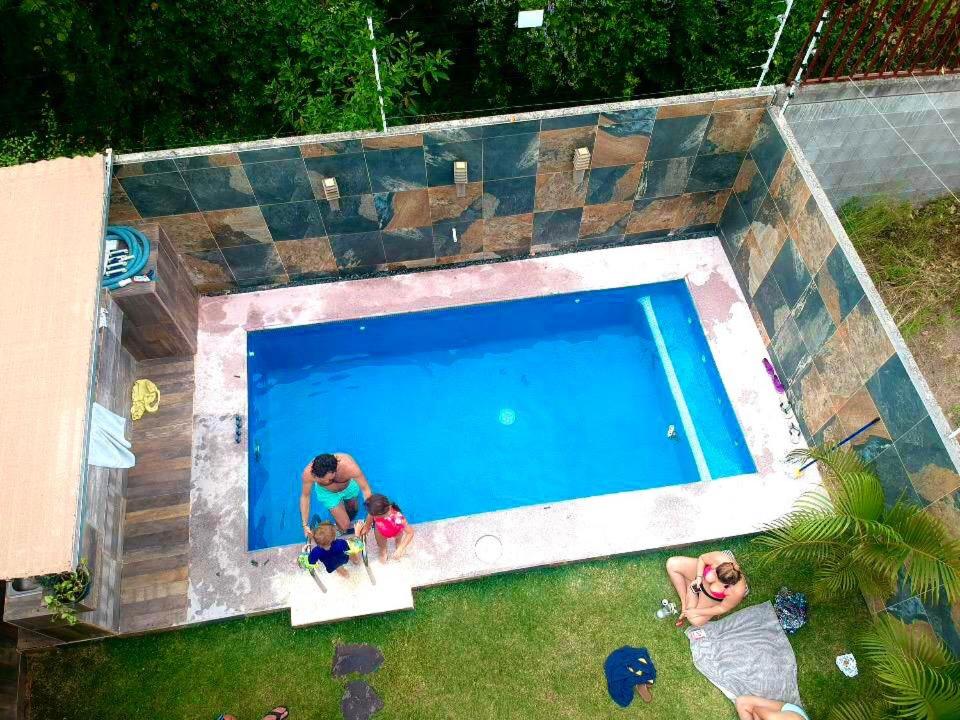 an overhead view of two people playing in a swimming pool at Marineros Vallarta in Puerto Vallarta