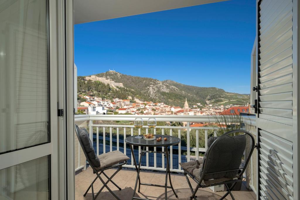 a balcony with a table and chairs and a view at Guesthouse Novak in Hvar