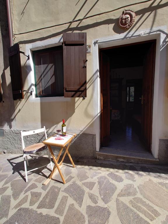 a table and a chair sitting outside of a building at Casa Ferrini in Marciana