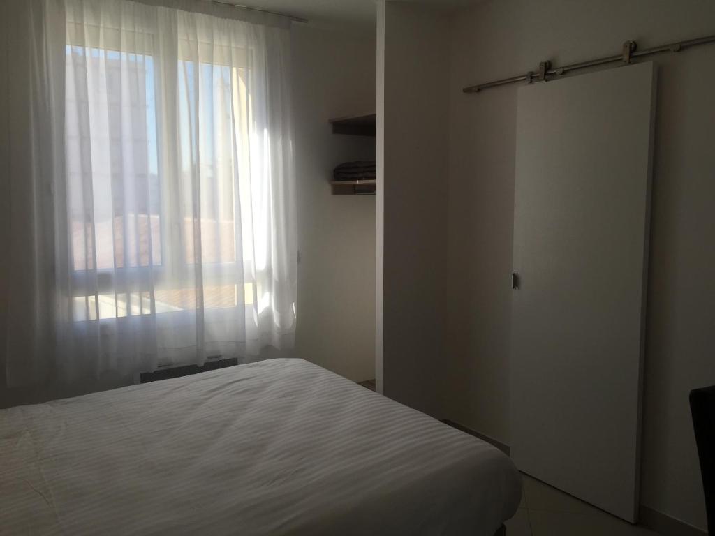 Postel nebo postele na pokoji v ubytování Le Logis Dauphinois