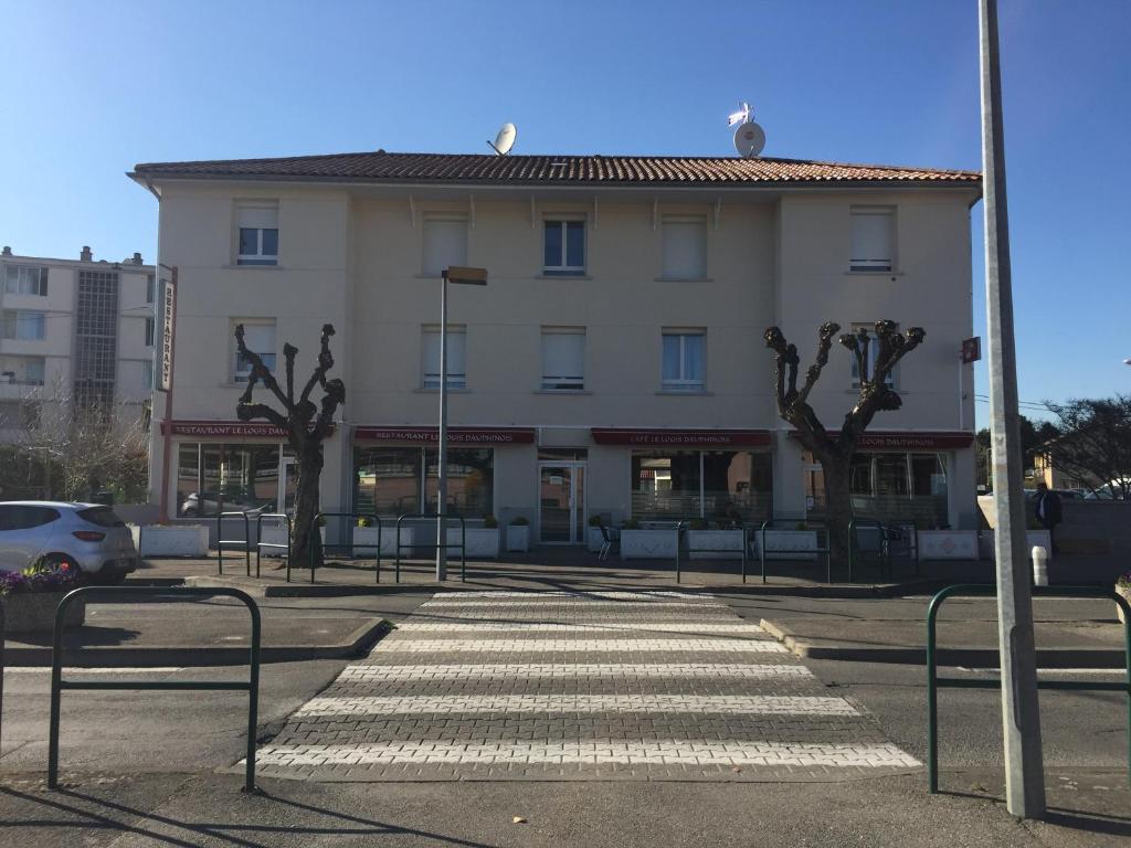 a building with a crosswalk in front of a building at Le Logis Dauphinois in Roussillon en Isere