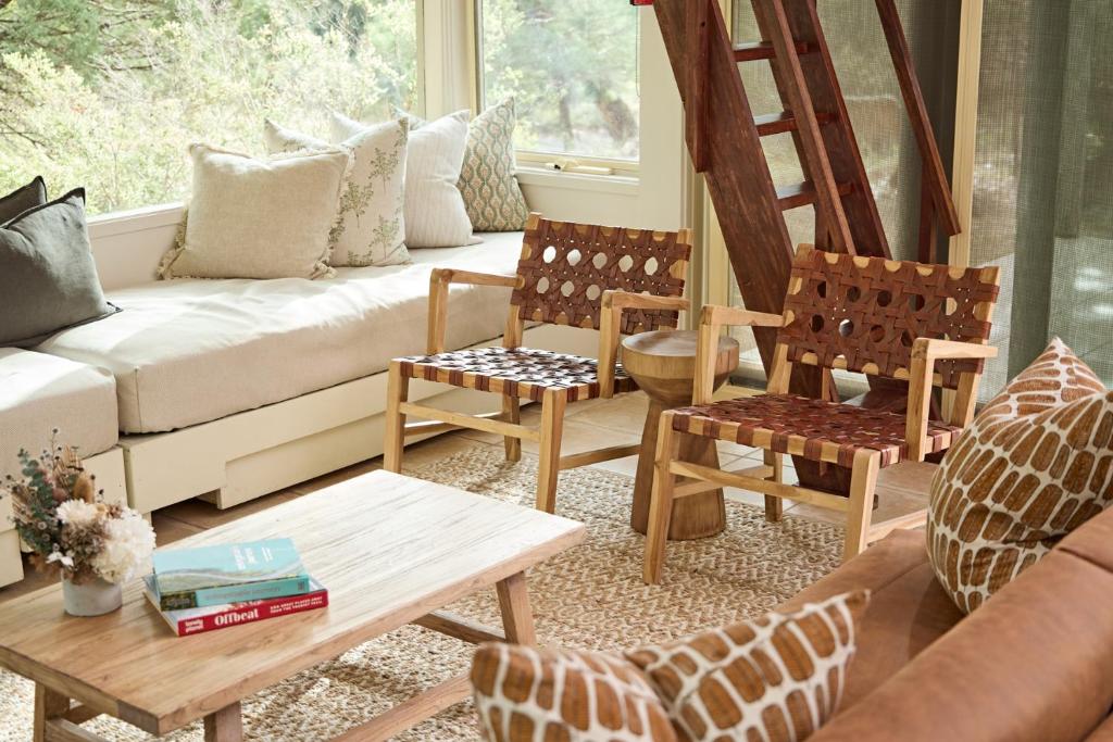 a living room with a couch and chairs and a table at Aquila Eco Lodges in Dunkeld